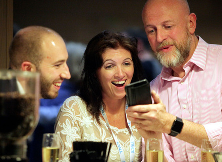 Members looking at smartphone